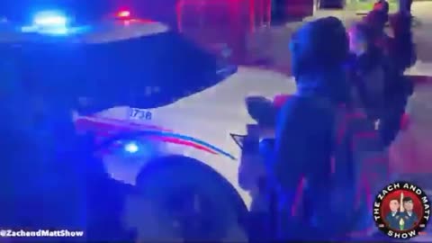 DC Protesters surround a police car.