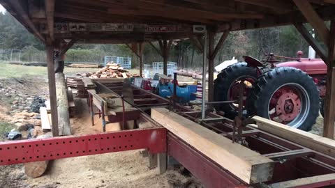 Sawing logs on the Foley Belsaw Sawmill