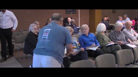 Mike hands out pamphlets about wasteful spending in Sherwood after arrest threat