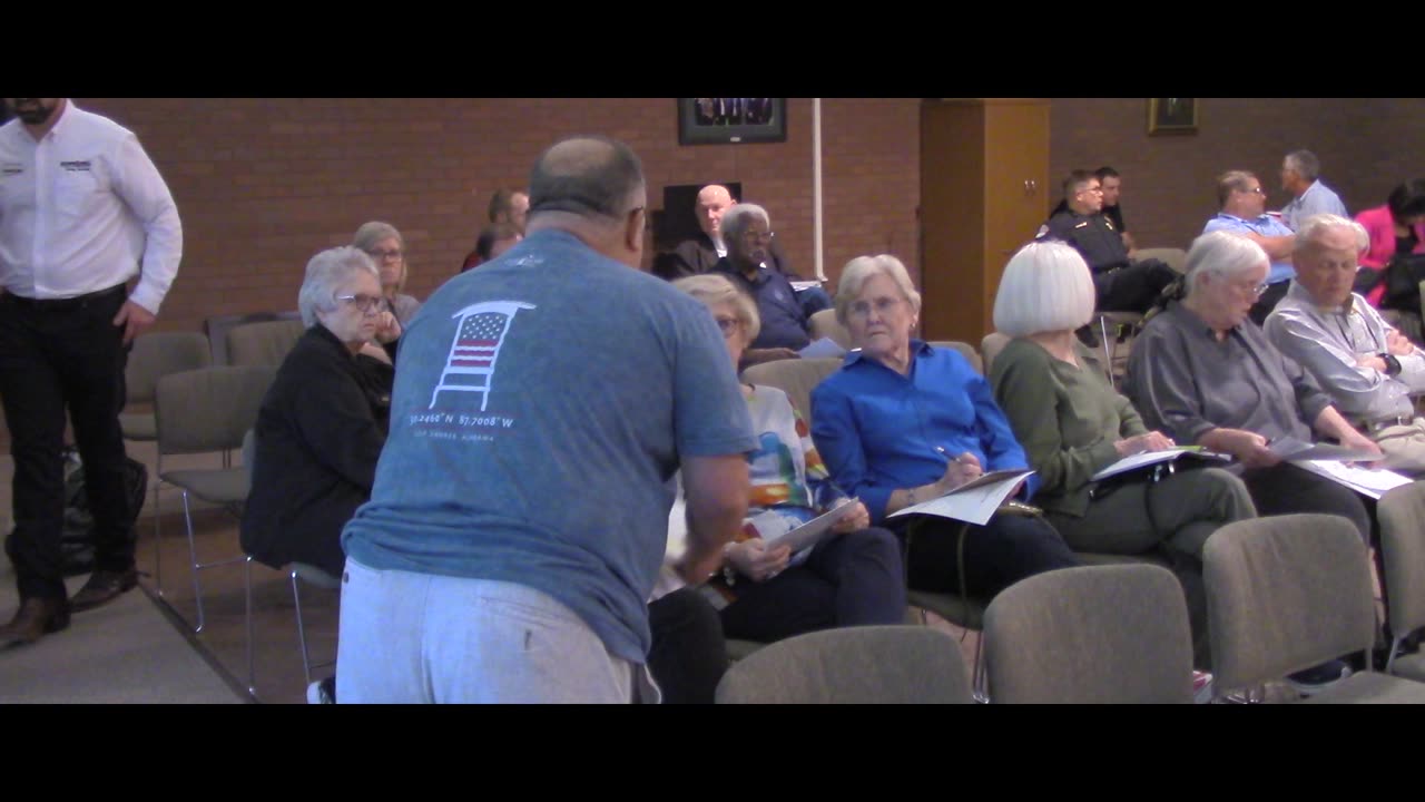 Mike hands out pamphlets about wasteful spending in Sherwood after arrest threat