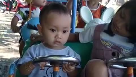 Cute baby riding "odong odong" - Child's toy in Indonesia