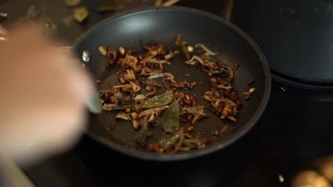 Close Up of Female Hands Stirring Frying Pan Contents