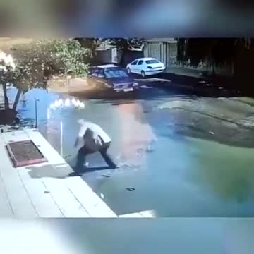 Footage shows a driver rescuing a child from drowning in a giant pothole