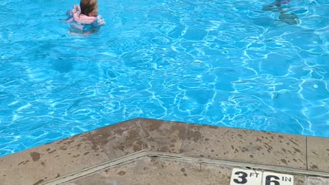 Josie swimming with her big sisters