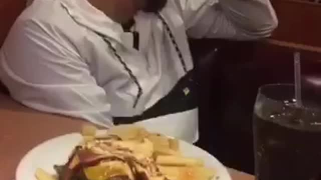 Friend throws bun at friends face