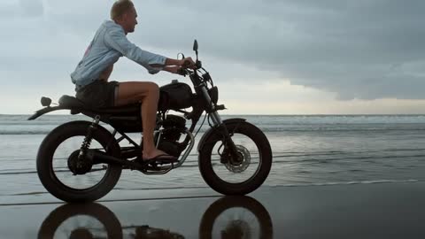 Biker riding on the beach