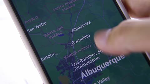 Hands of people using smartphone map apps
