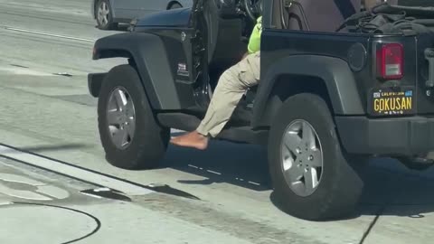 Driver Lets His Foot Hang Loose on the Highway