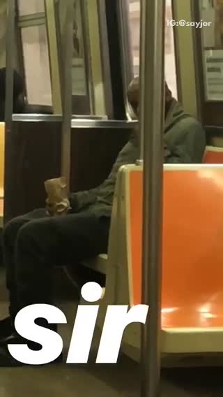 Guy in black smoking on train