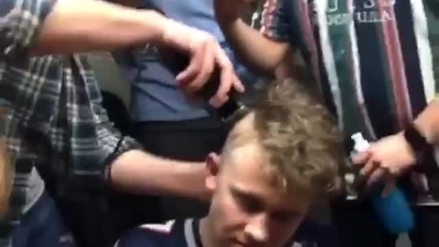 Guys recording friend shave patriots jersey friends head