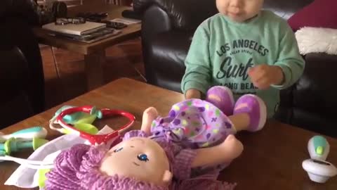 she is trying to check up her baby doll -fayenne