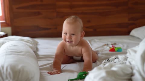 A Happy And Funny Baby On Bed