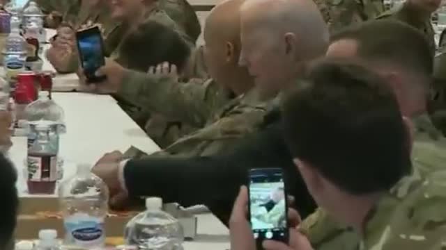 Pres. Biden eats pizza with service members in Rzeszow, Poland