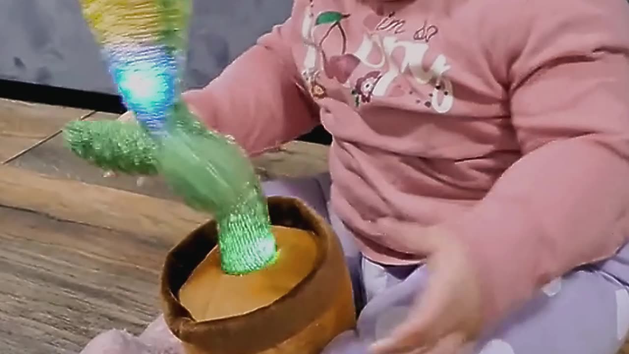 baby playing with cactus toy