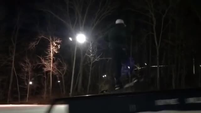 Night snowboard railslide faceplant