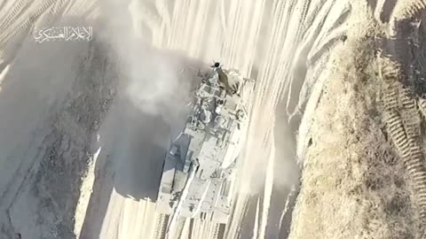 Dropping a shaped charge munition from a Hamas drone on an Israeli Merkava.