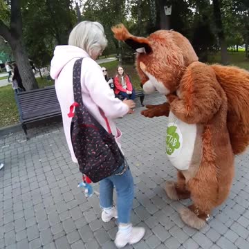 A kind girl feeds a squirrel )