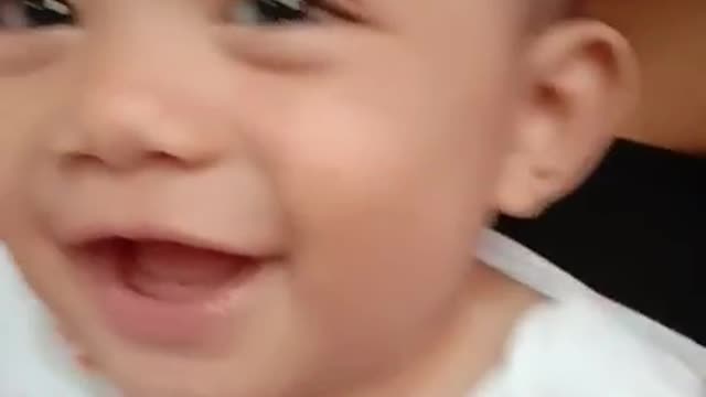 A baby can't stop laughing