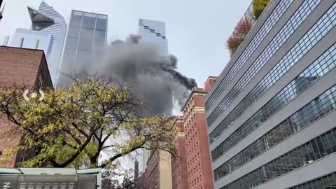 Fire rips through roof of skyscraper filling NYC skyline with smoke