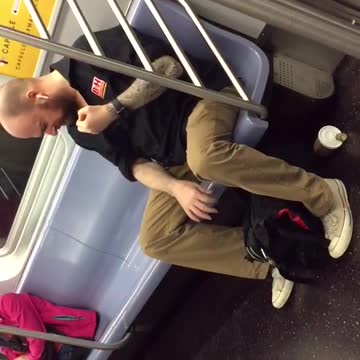 Man playing fake air guitar on train