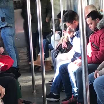 Man dances on subway full of sleepy people