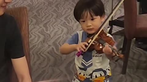 3 year old plays the violin for uncles birthday