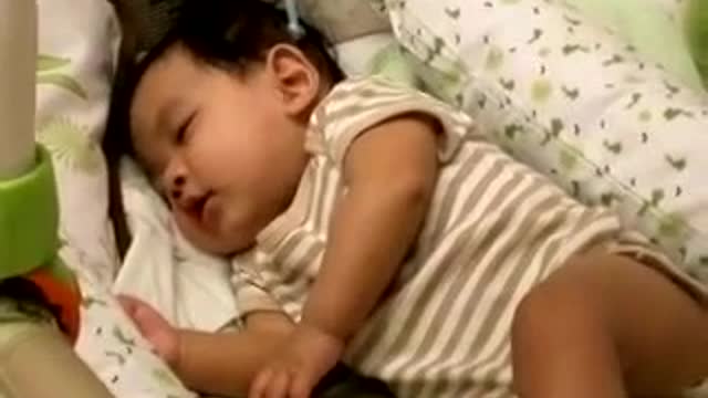 Baby laughing Adorably While Sleeping