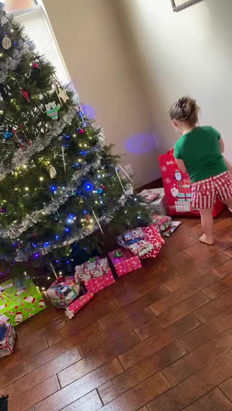 Little Girl opening Presents on Christmas Morning