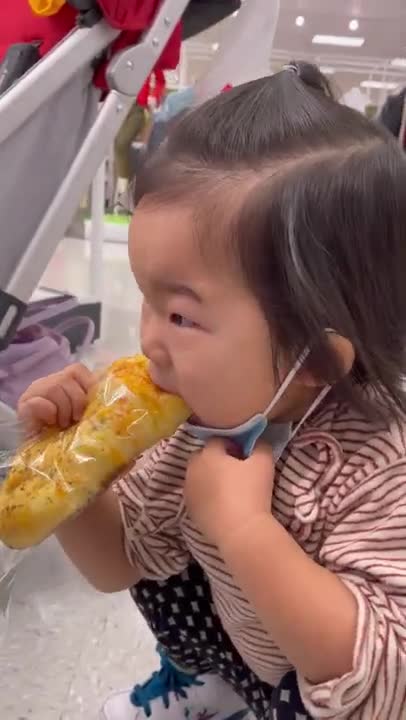 Cute toddler tries to eat bread while wearing face mask #shorts
