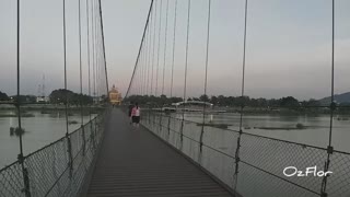 Crossing a suspended bridge over the river Mae Nam Ping in Tak, Thailand