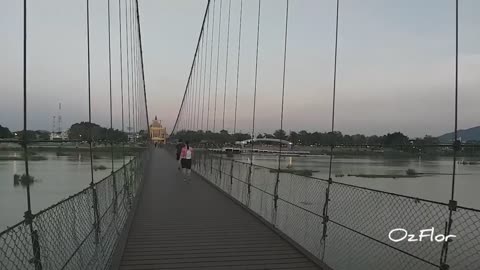 Crossing a suspended bridge over the river Mae Nam Ping in Tak, Thailand