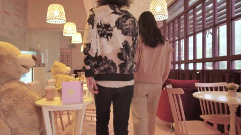 Couple walking into a romantic cafe on a date