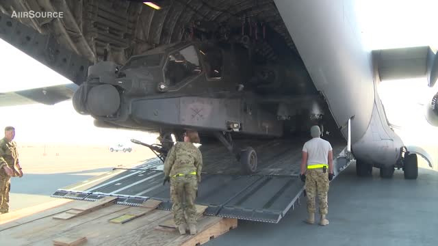 Unloading AH - 64 Apache helicopter from C 17 Globemaster.
