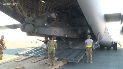 Unloading AH - 64 Apache helicopter from C 17 Globemaster.