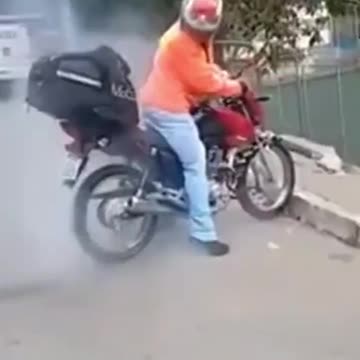He tries burnout on a motorcycle