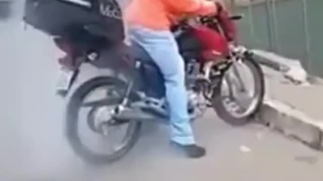 He tries burnout on a motorcycle