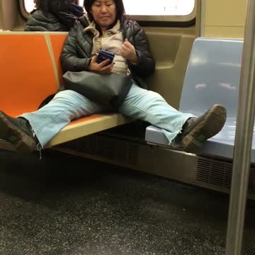 Woman on subway spreads legs across four chairs at once