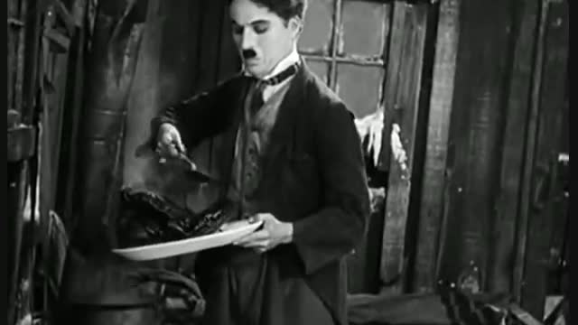 Charlie Chaplin Eating His Shoe - The Gold Rush