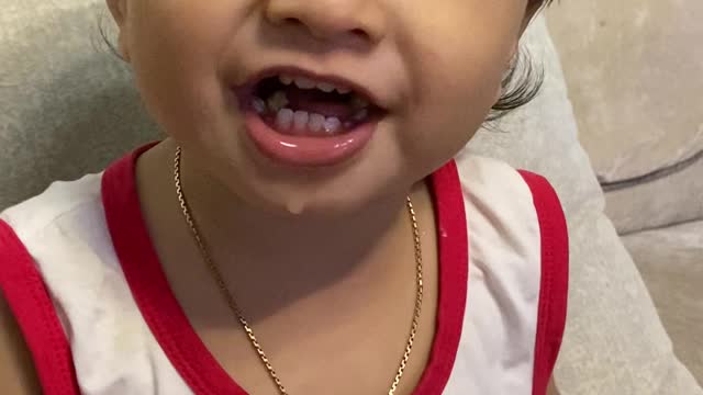 Cute baby boy eating fruits and watching cartoon