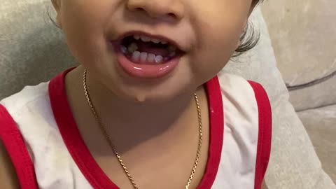 Cute baby boy eating fruits and watching cartoon