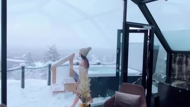A Girl bathes in a jacuzzi in winter
