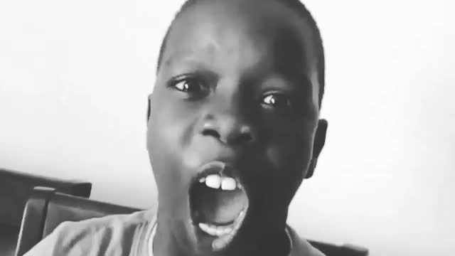 African kid shows off his white teeth while laughing