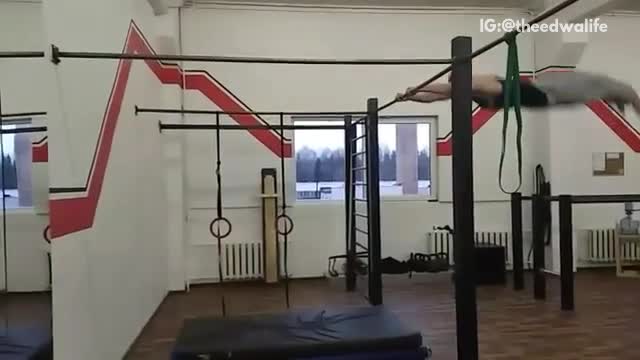 Black tank grey pants slams head on wall after swinging