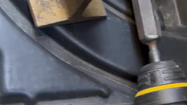 Using a rotary hammer to beat out a dent in a quarter panel