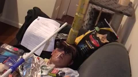 Man passed out with cans on face on couch