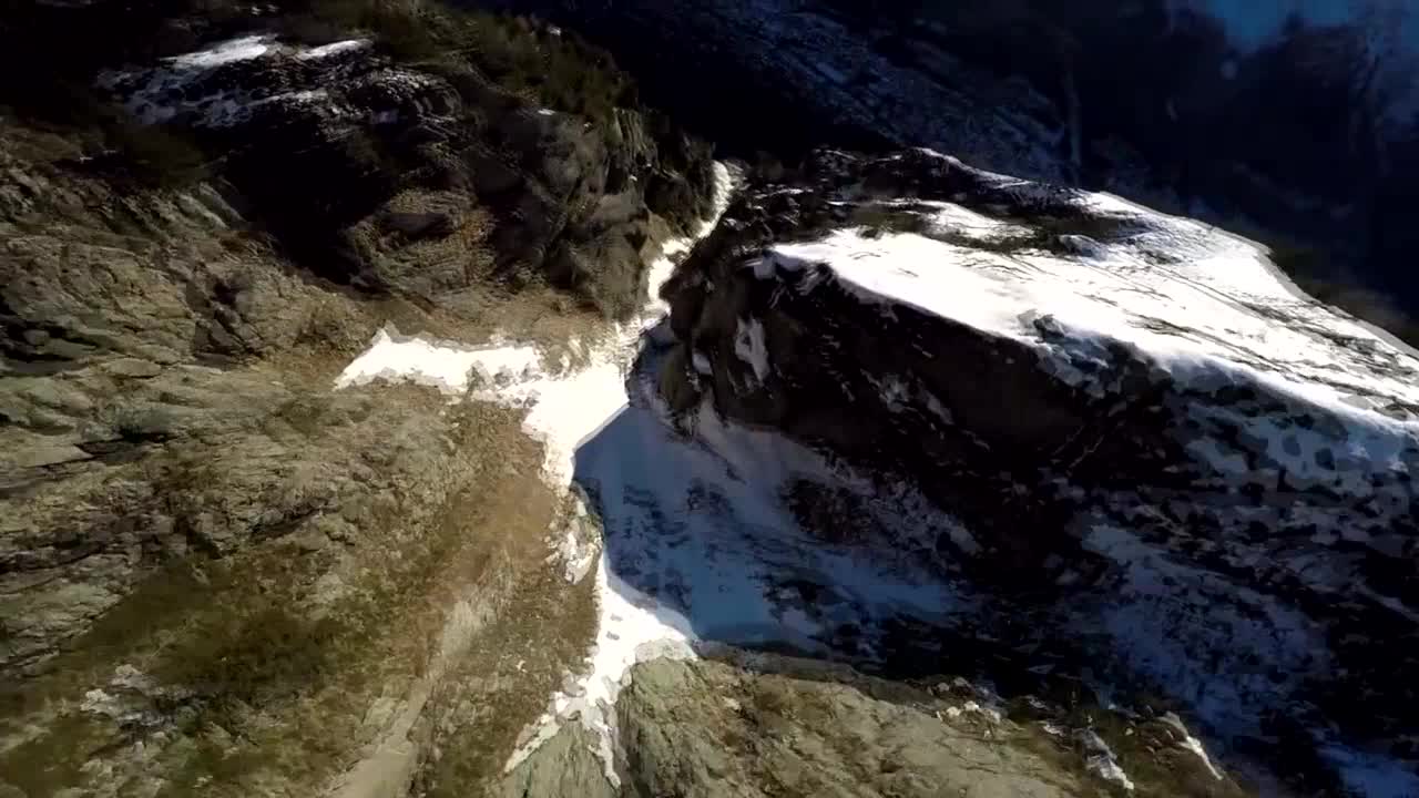 Daredevils soar above snow-covered mountains