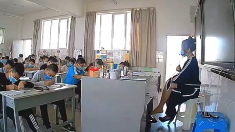 Teacher dangling behind the desk...