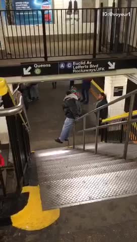 Man slides down staircase handrail in subway station