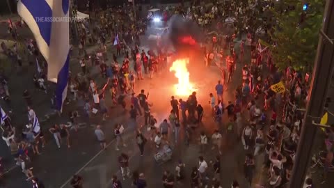 Demonstrators light bonfire during protest and scuffle with Israeli police