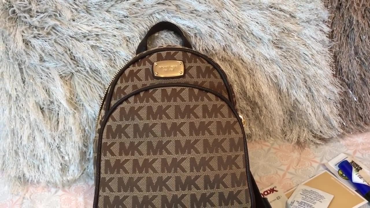 What can fit inside the Michael Kors Abbey XS Backpack Purse